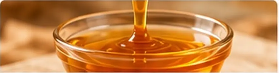 Light golden date syrup flowing into a glass bowl